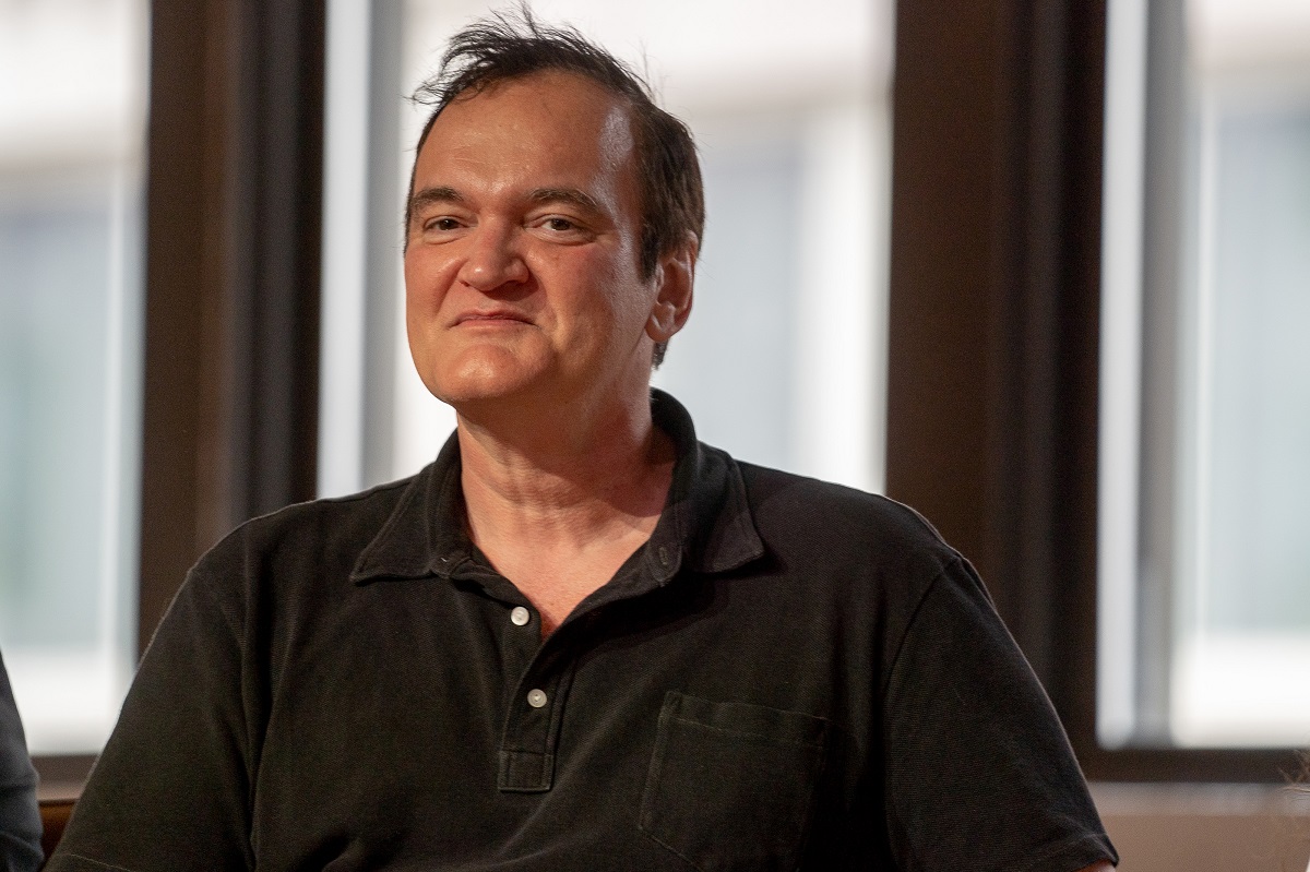 Quentin Tarantino sitting down smiling.