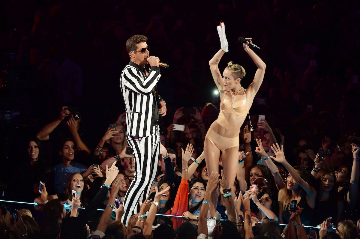 Miley Cyrus, who compared her 2013 VMAs performance with Robin Thicke to Madonna and Britney Spears, performs with Robin Thicke at the 2013 MTV Video Music Awards