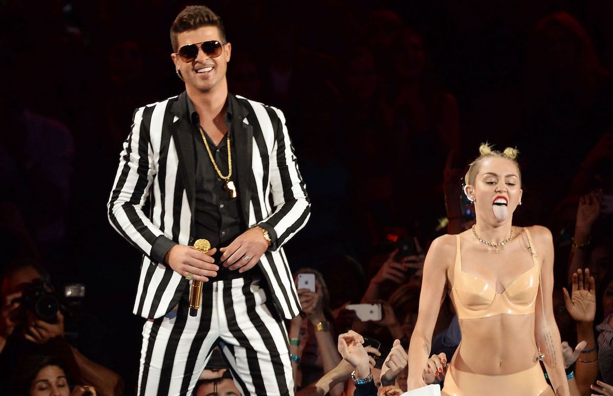 Robin Thicke and Miley Cyrus, who compared her 2013 VMAs performance to Madonna and Britney Spears, perform at the 2013 MTV VMAs