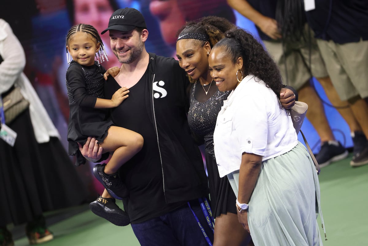 Serena Williams stands with her husband Alexis Ohanian, who's holding their daughter Olympia Ohanian Jr., and her sister Isha Price at the 2022 U.S. Open