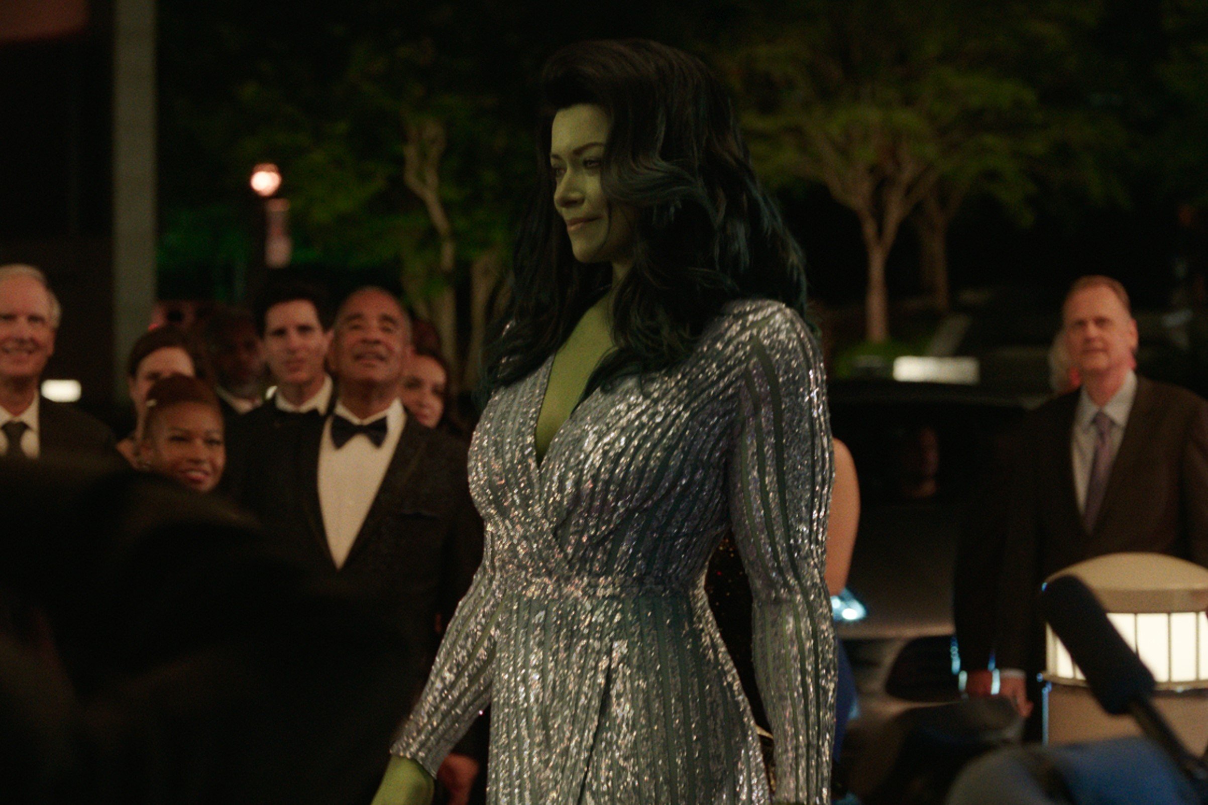 Tatiana Maslany, in character as Jennifer Walters/She-Hulk in 'She-Hulk: Attorney at Law,' wears a long-sleeved sparkly silver dress.