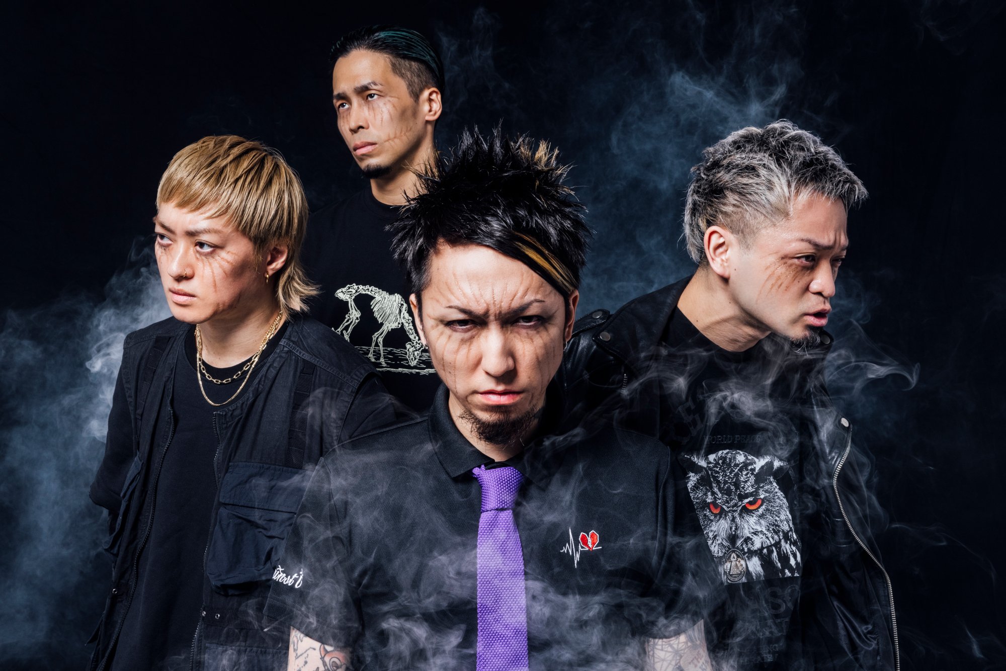 SiM, the Japanese band behind 'Attack on Titan's hit theme, 'The Rumbling.' In the image, they all have makeup that looks like Titan markings under their eyes.