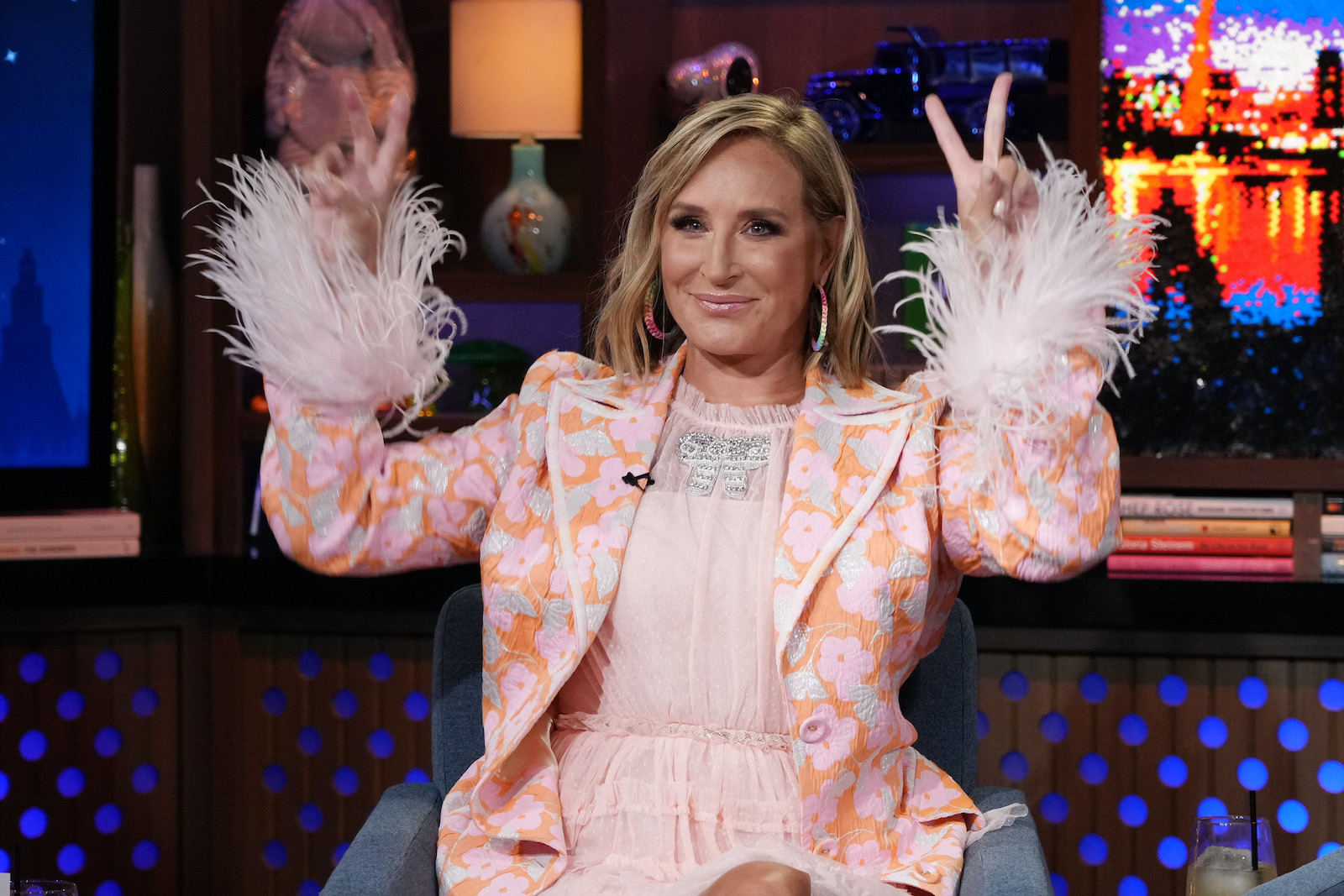 Sonja Morgan from 'RHONY' shows the peace sign while sitting in a chair on 'WWHL'