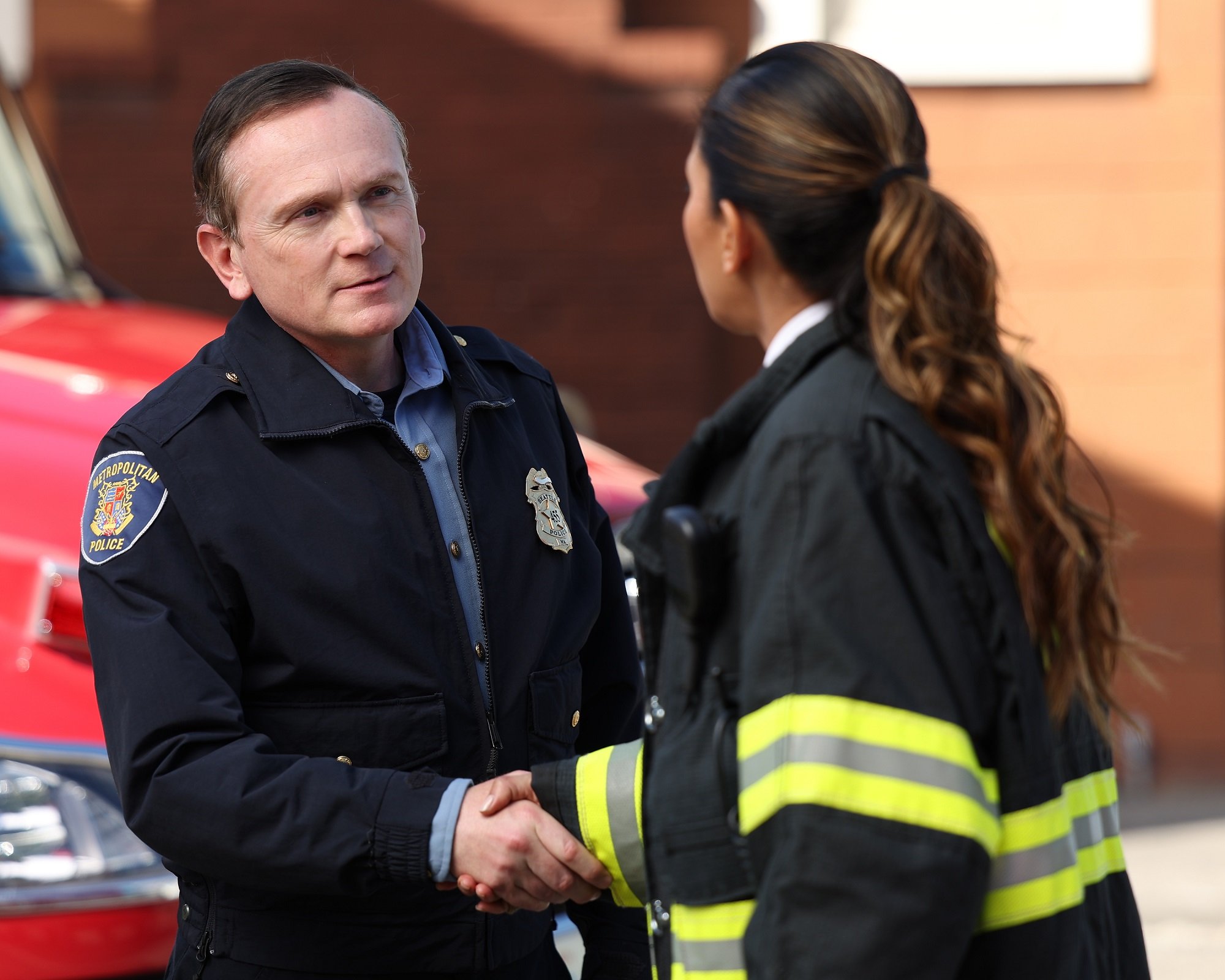 'Station 19' Season 6 cast regular Pat Healy shakes hands with Merle Dandridge