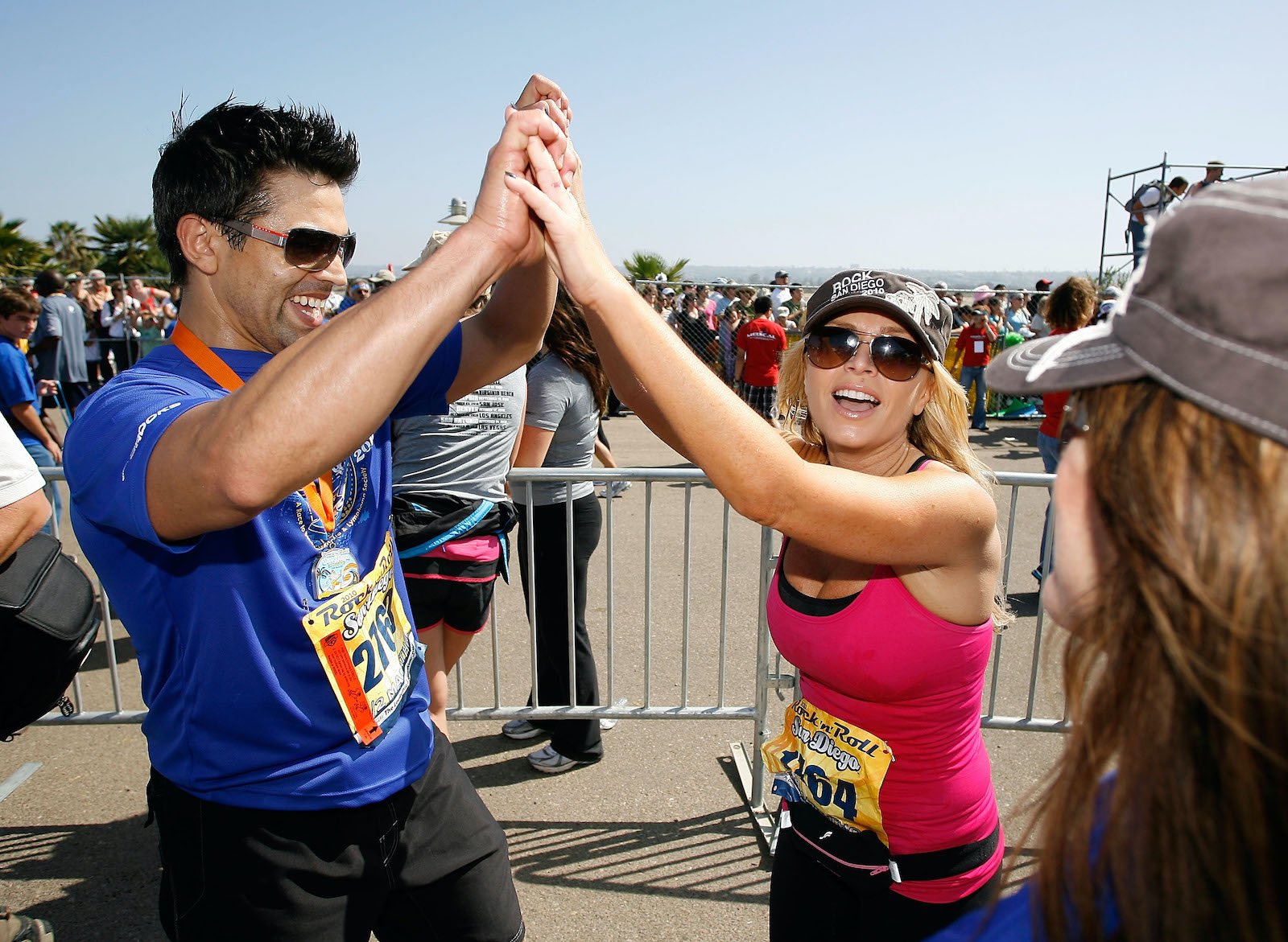 Eddie Judge and Tamra Judge from 'RHOC' give each other a high-five after a race 