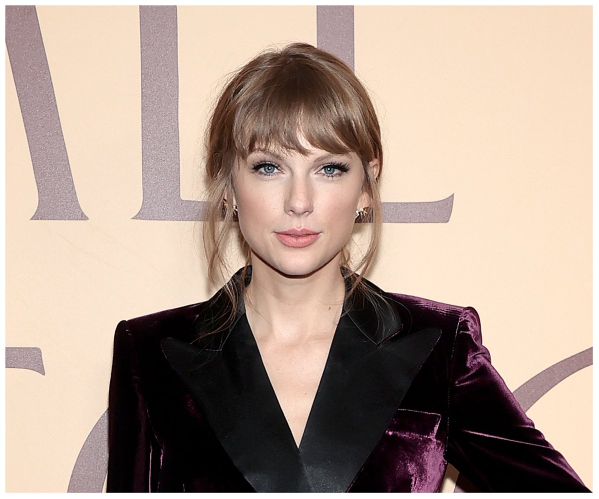 Taylor Swift, who has three pet cats, poses at an event.