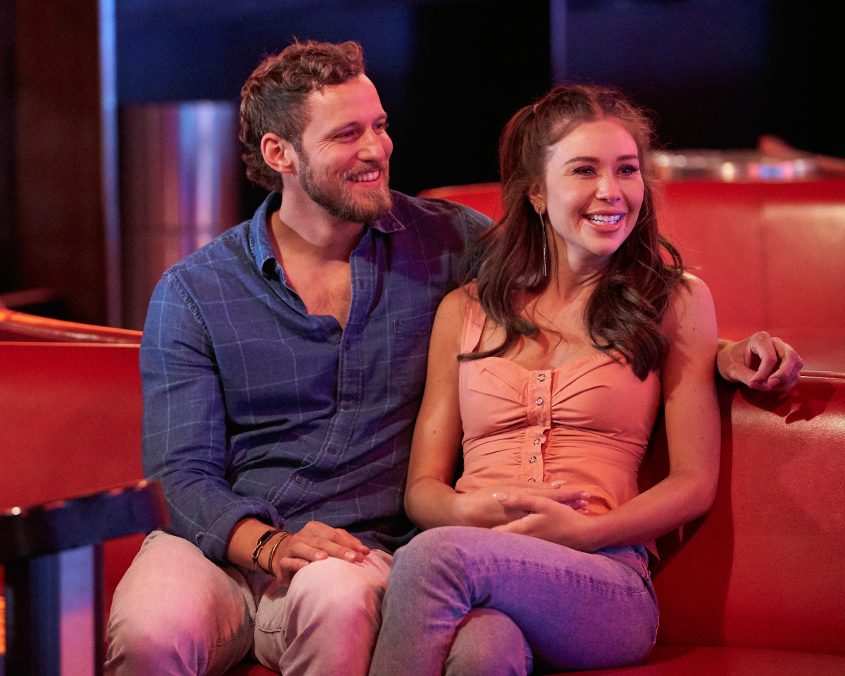 The Bachelorette 2022 Week 7 was dedicated to Allan Schwer. Erich and Gabby sit at a bowling alley together, smiling.