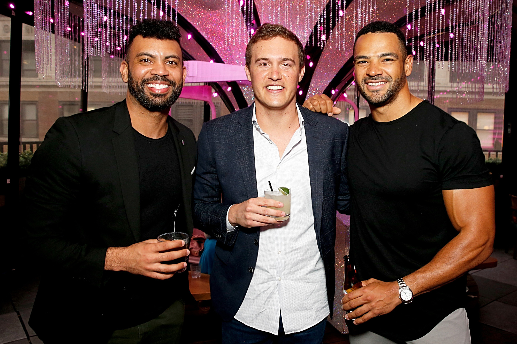 'The Bachelor' alums Dustin Kendrick, Peter Weber, and Clay Harbor. They're standing next to one another, holding drinks, and smiling.