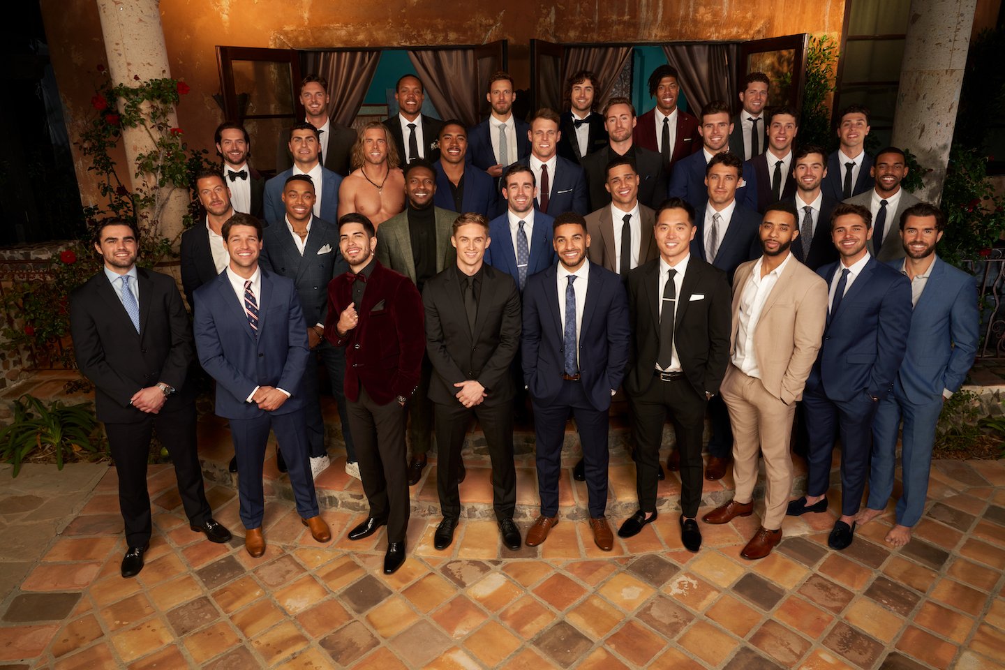 'The Bachelorette' Season 19 cast standing together in suits and smiling