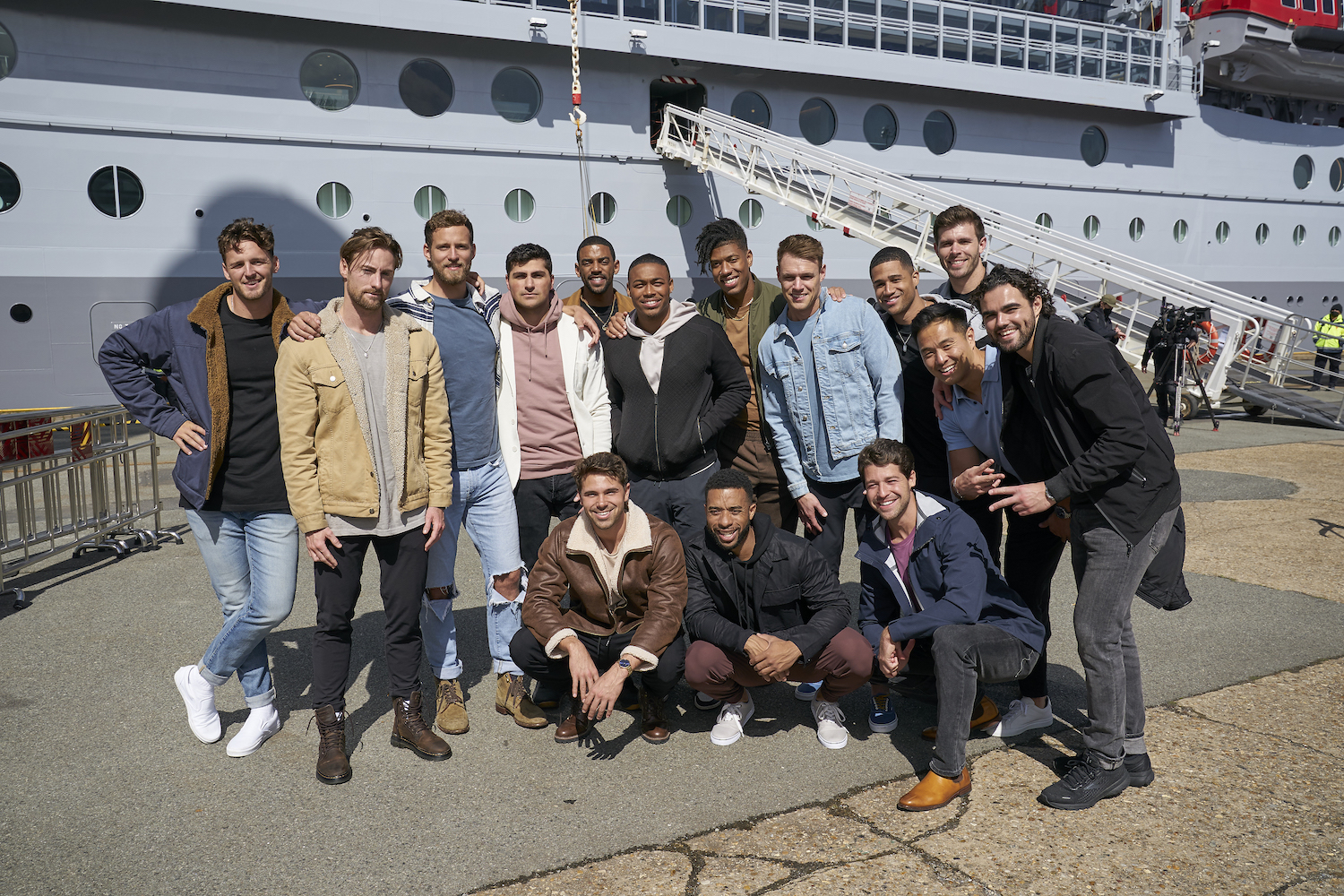 'The Bachelorette' Season 19 cast standing together outside of the cruise ship. Many of the men appear on the 'Men Tell All' special.
