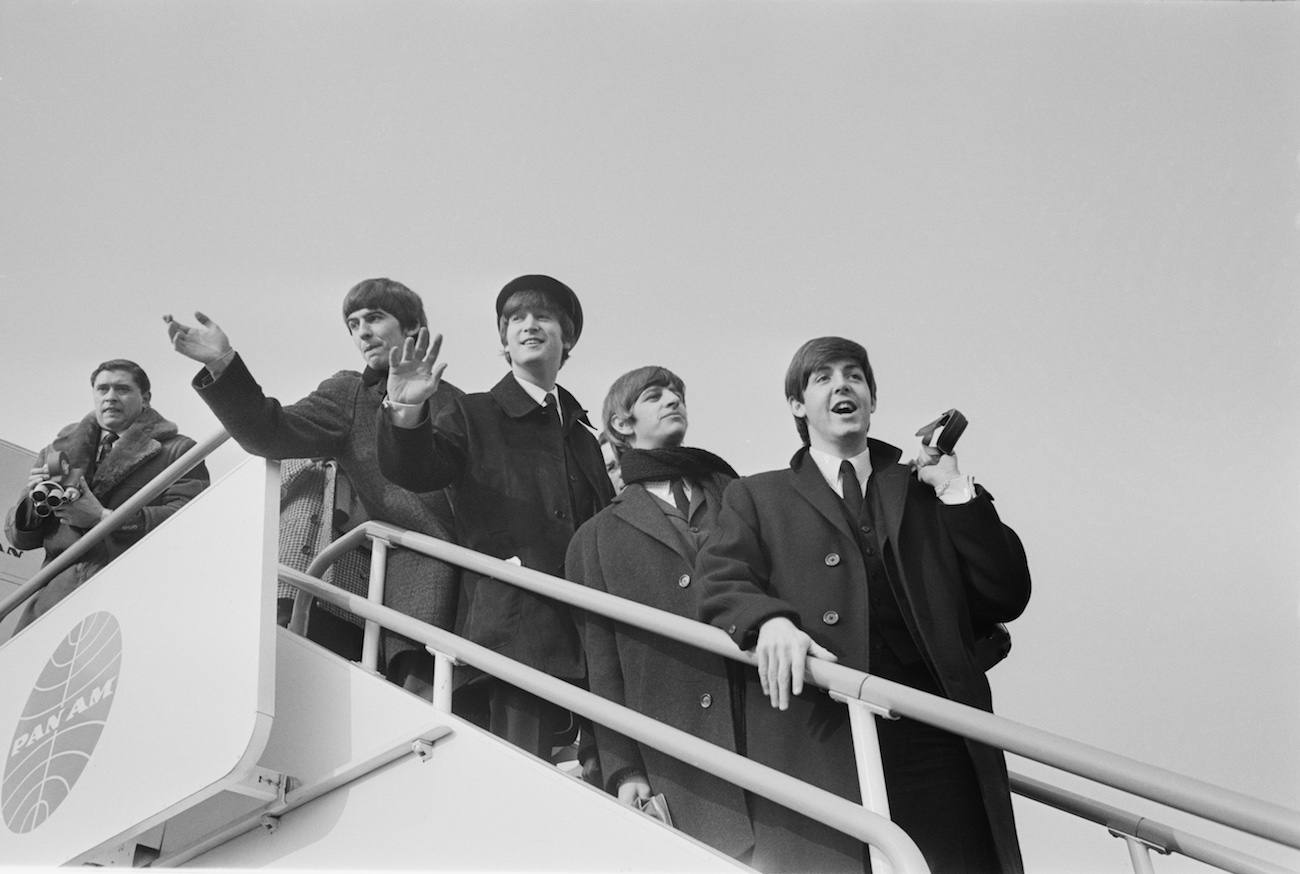 The Beatles departing at the airport in 1964.