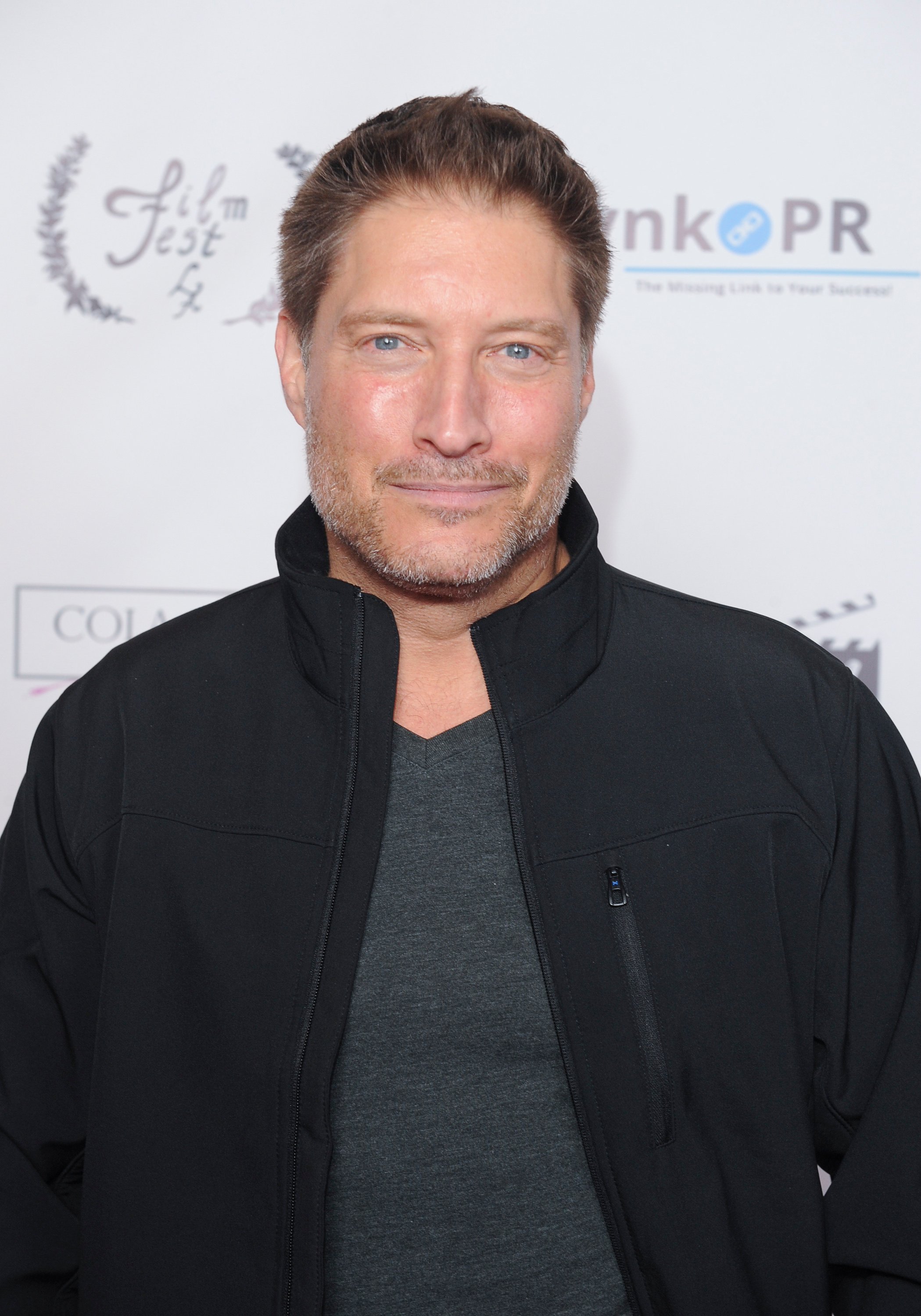 'The Bold and the Beautiful' star Sean Kanan wearing a grey shirt and black jacket; while posing for photographers.