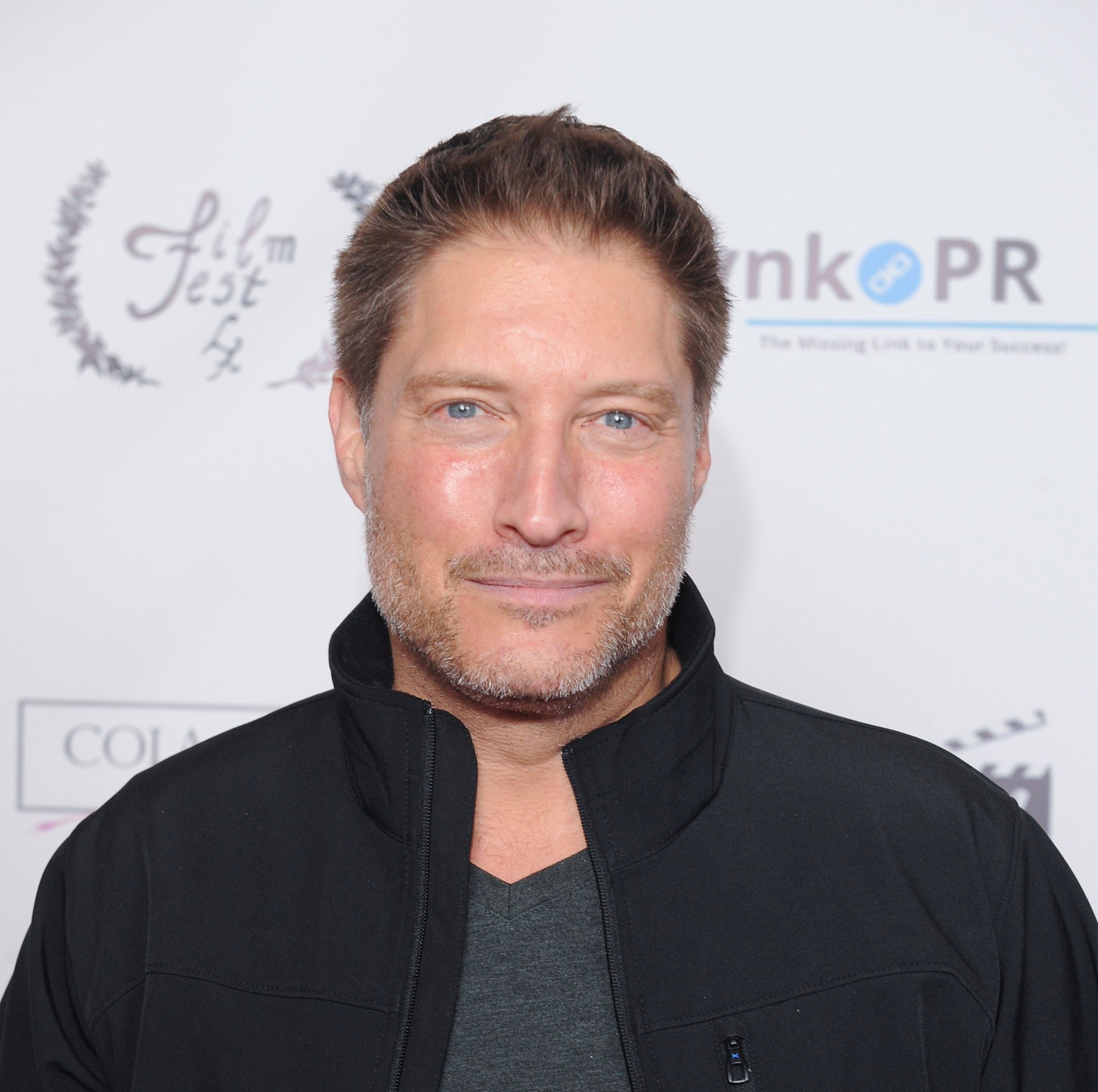 'The Bold and the Beautiful' star Sean Kanan wearing a grey shirt and black jacket; while posing for photographers.