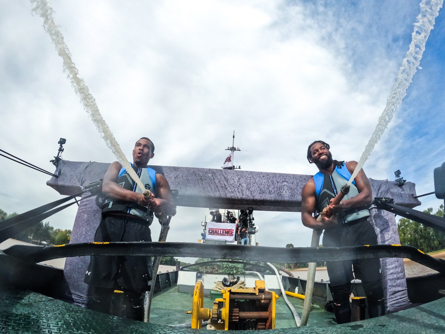 David Alexander and Danny McCray holding hoses during a challenge in 'The Challenge: USA' episode 8