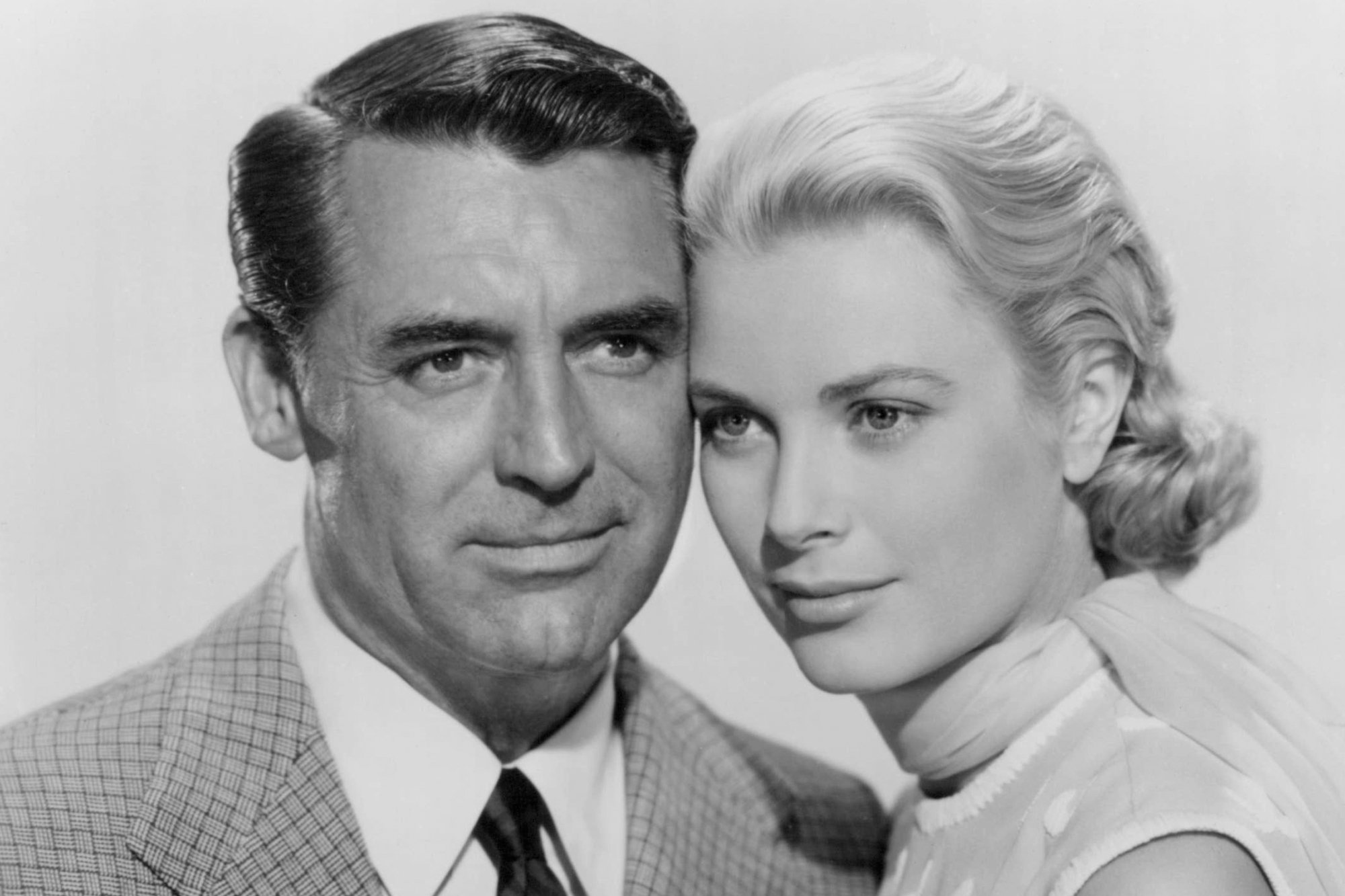 'To Catch a Thief' actors Cary Grant and Grace Kelly in black-and-white. Kelly has her head rested gently against the side of Grant's head.