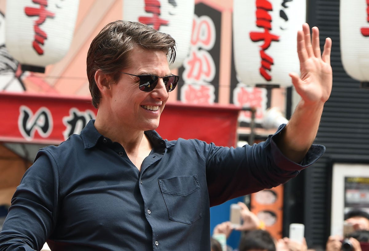 Tom Cruise, with a net worth of $600 million, waves to a crowd in Japan in 2014