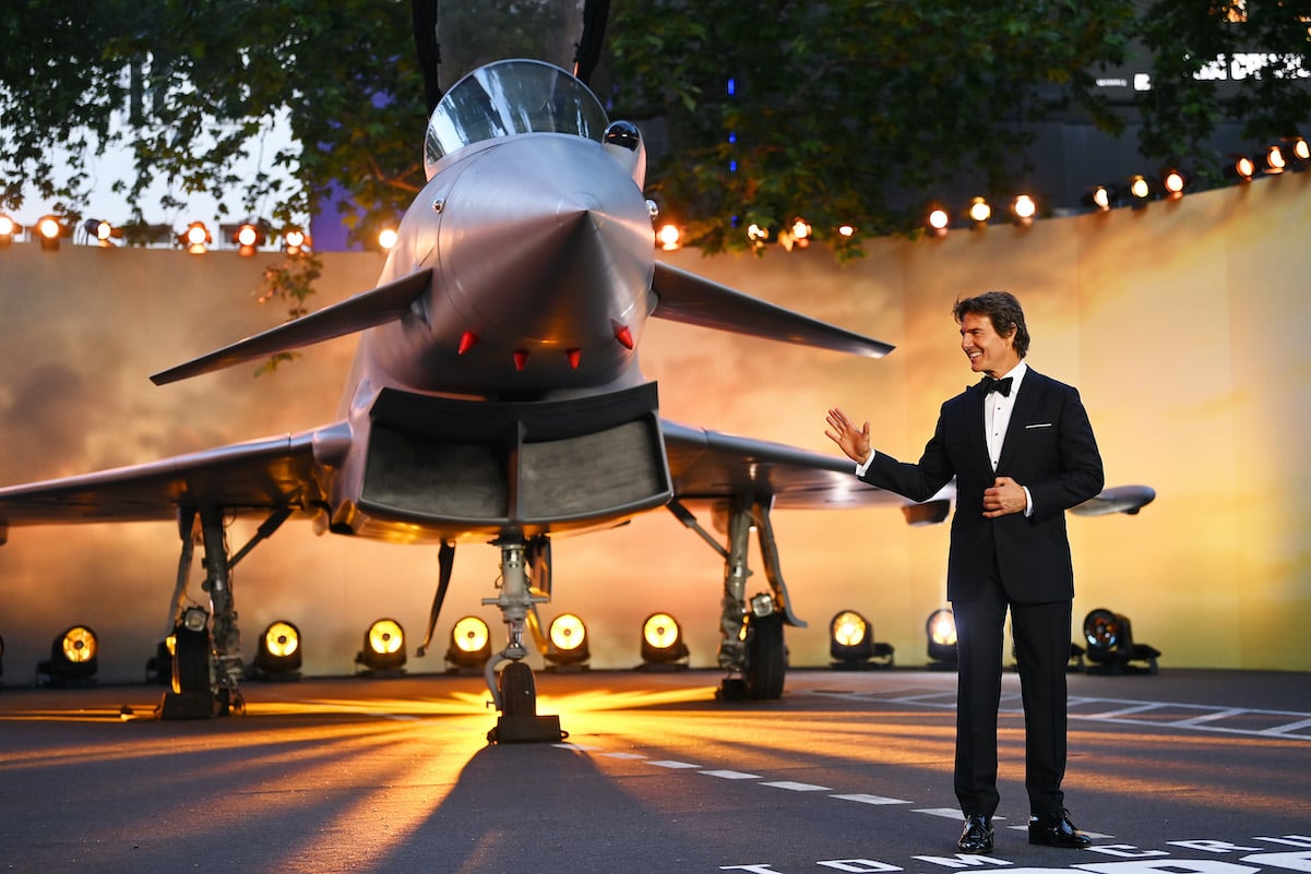 Tom Cruise, whose net worth is $600 million, waves during a photo at the UK premiere of 'Top Gun: Maverick'