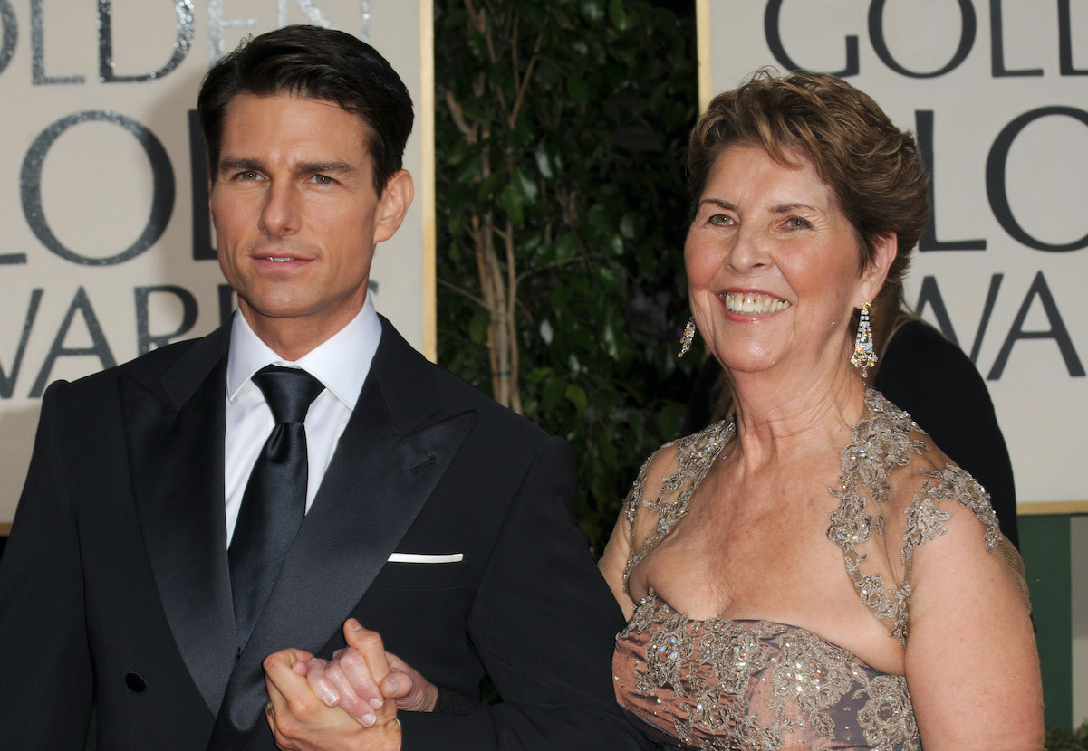 Tom Cruise, whose net worth is $600 million, holds hands with his mother at an event in 2009