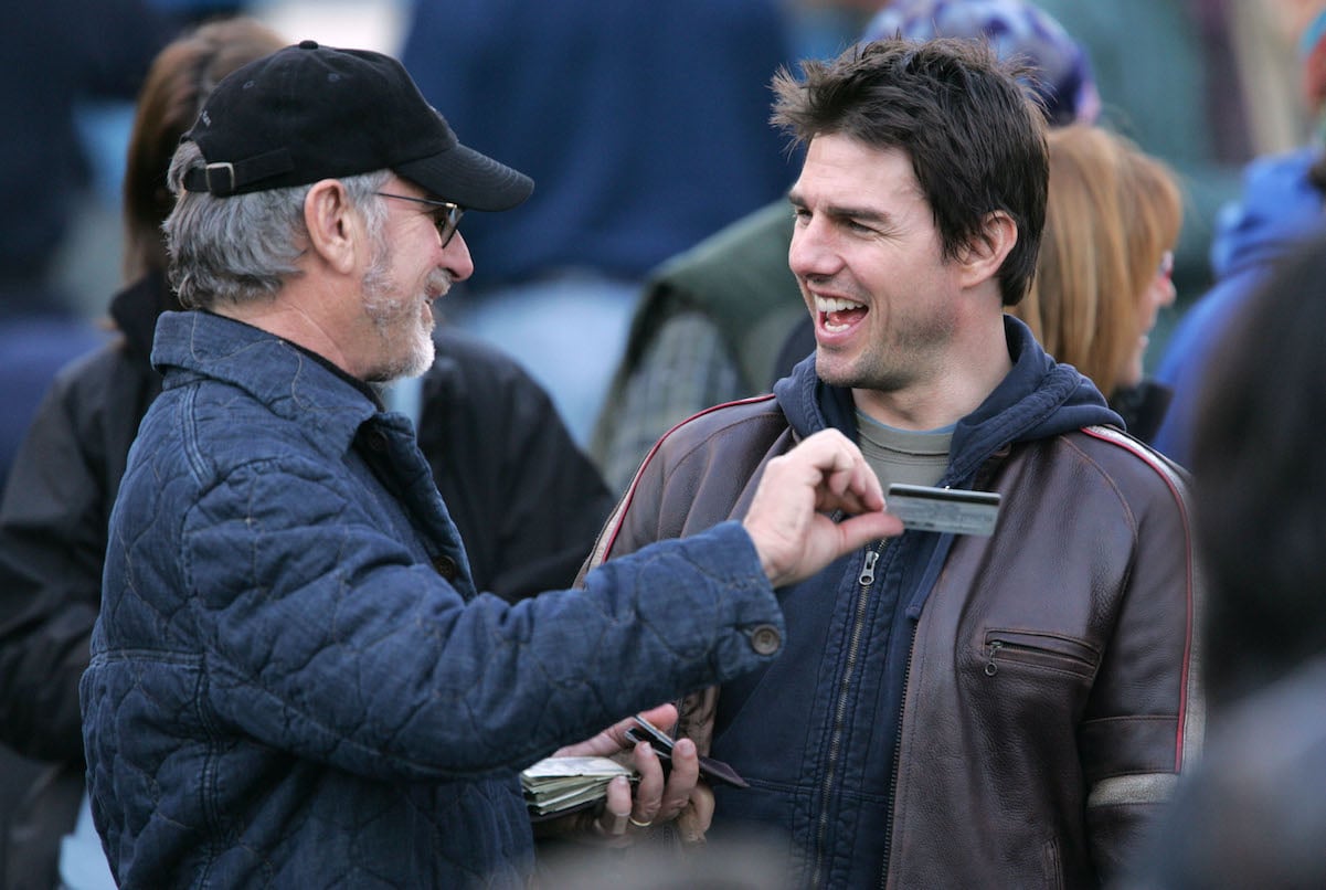 Tom Cruise, with a net worth of $600 million, talks to Steven Spielberg on the 'War of the Worlds' set in 2004