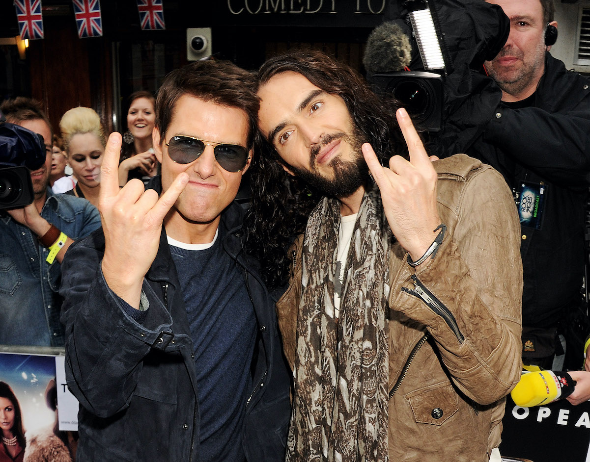 Tom Cruise, who earned a $600 million net worth, poses with Russell Brand in 2012