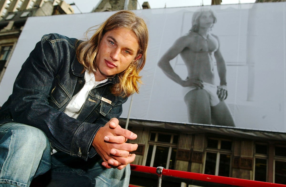 Travis Fimmel in front of his image on a billboard March 1, 2002 on Tottenham Court Road in central London