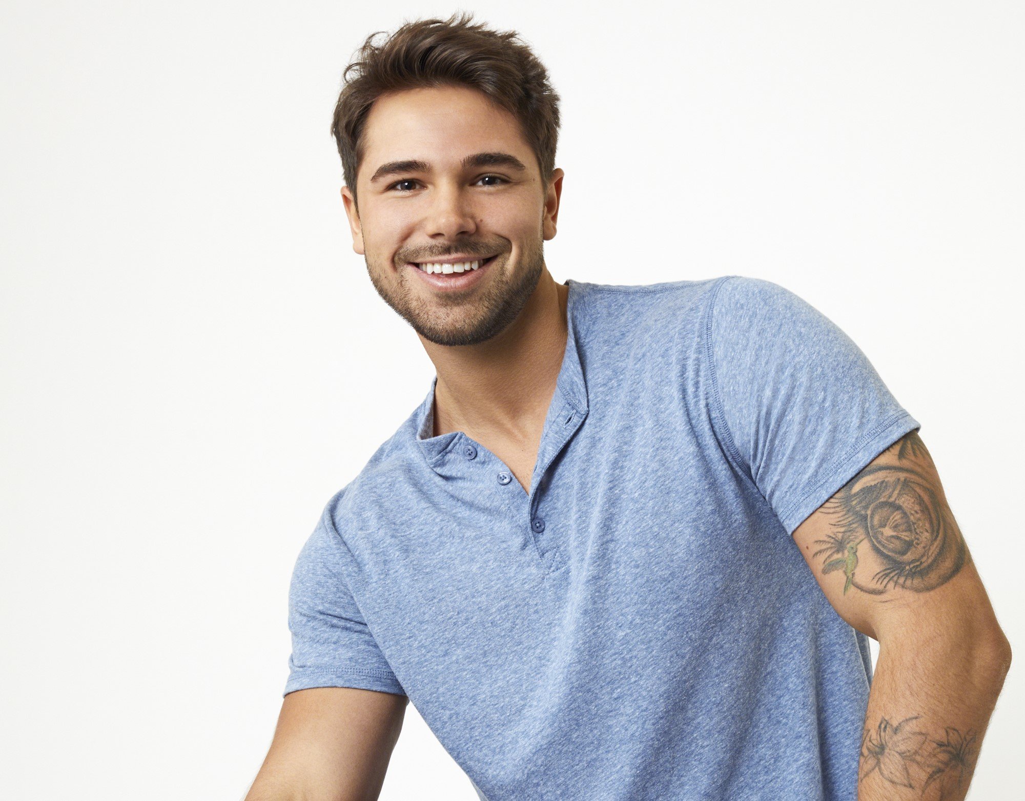 'The Bachelorette' 2022 contestant Tyler Norris. He's wearing a blue polo shirt and smiling at the camera.