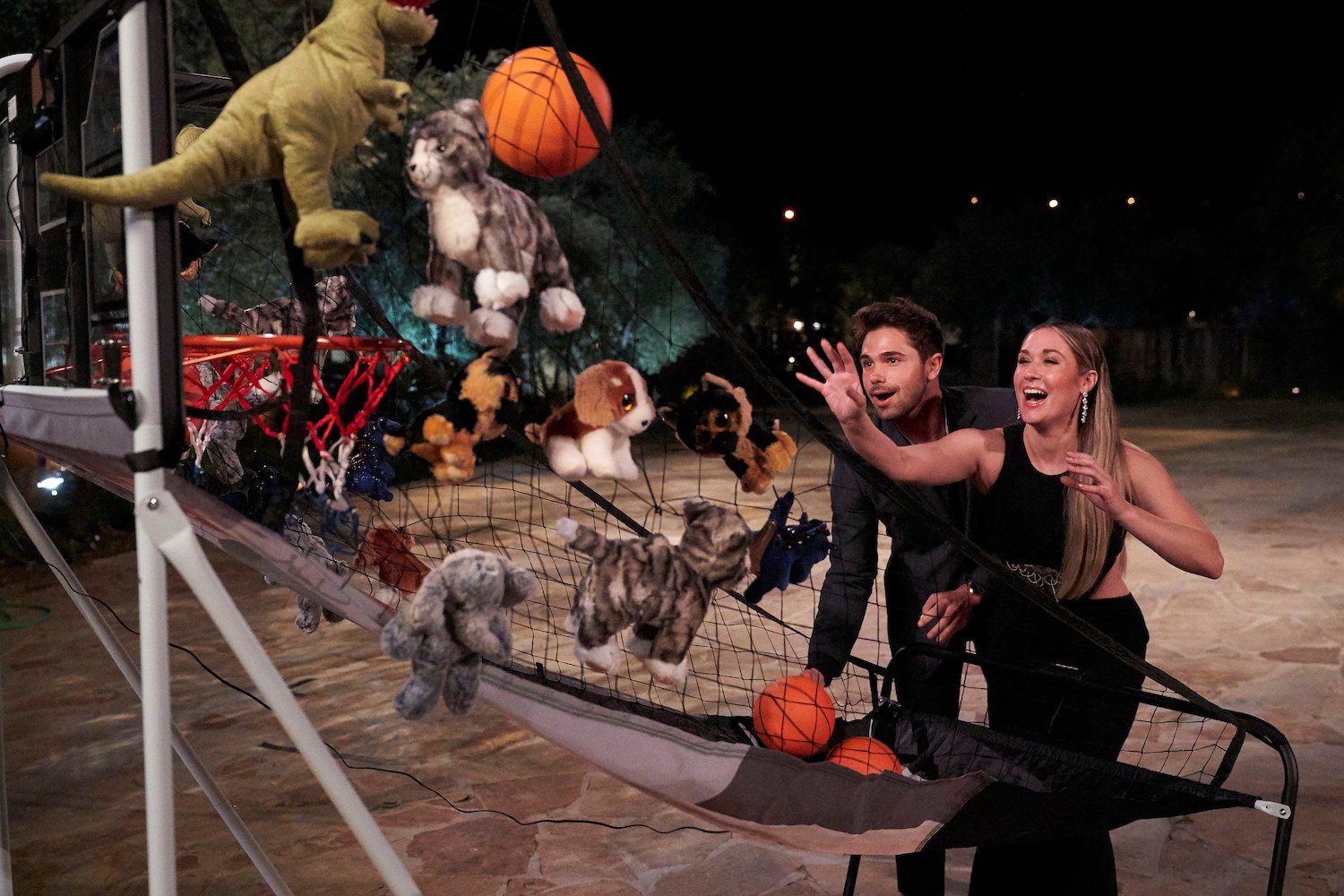 Tyler Norris and Rachel Recchia playing a carnival basketball game in 'The Bachelorette' Season 19. Tyler Norris is eliminated during hometowns.