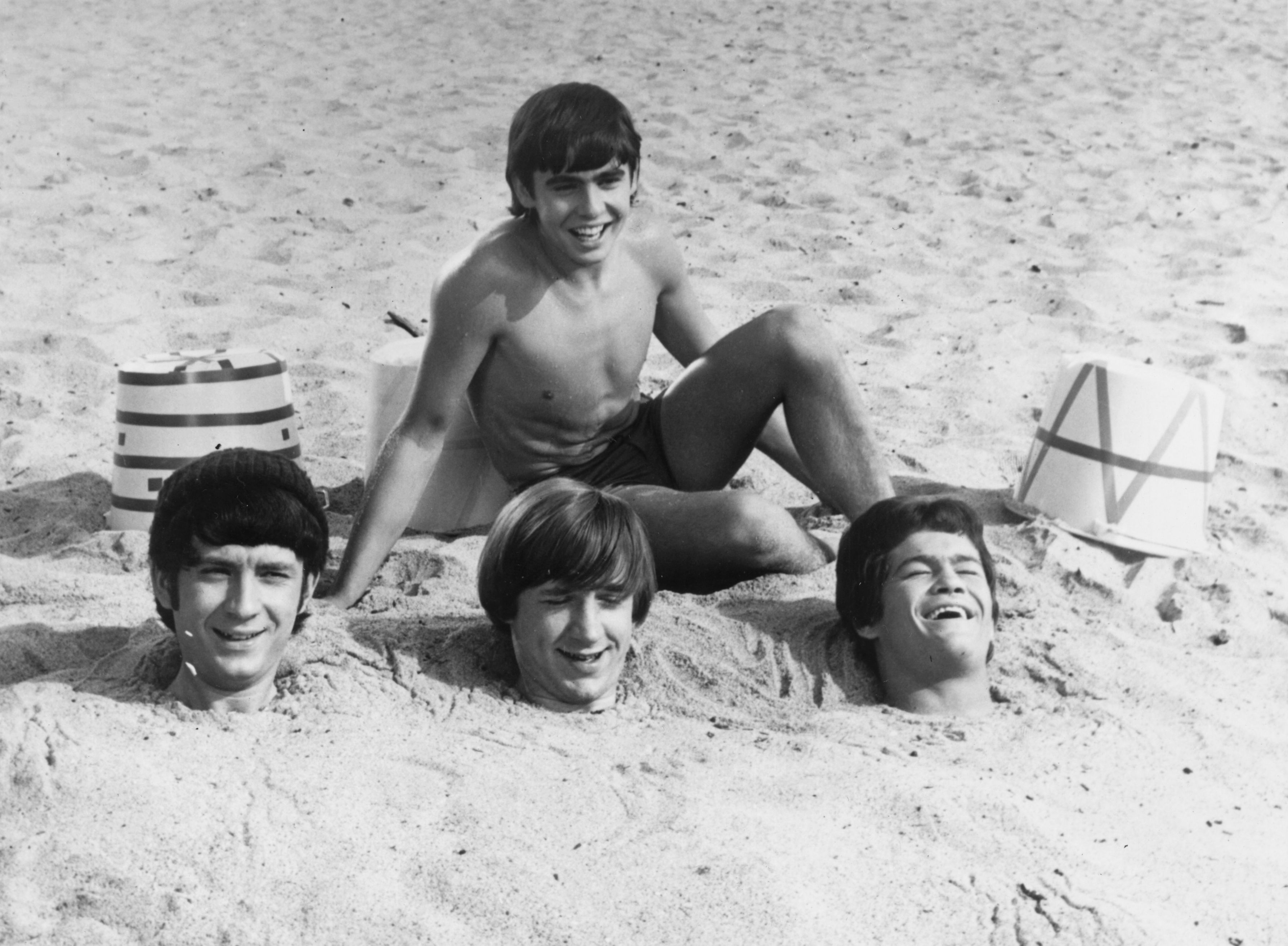 The Monkees' Mike Nesmith, Davy Jones, Peter Tork, and Micky Dolenz on a beach