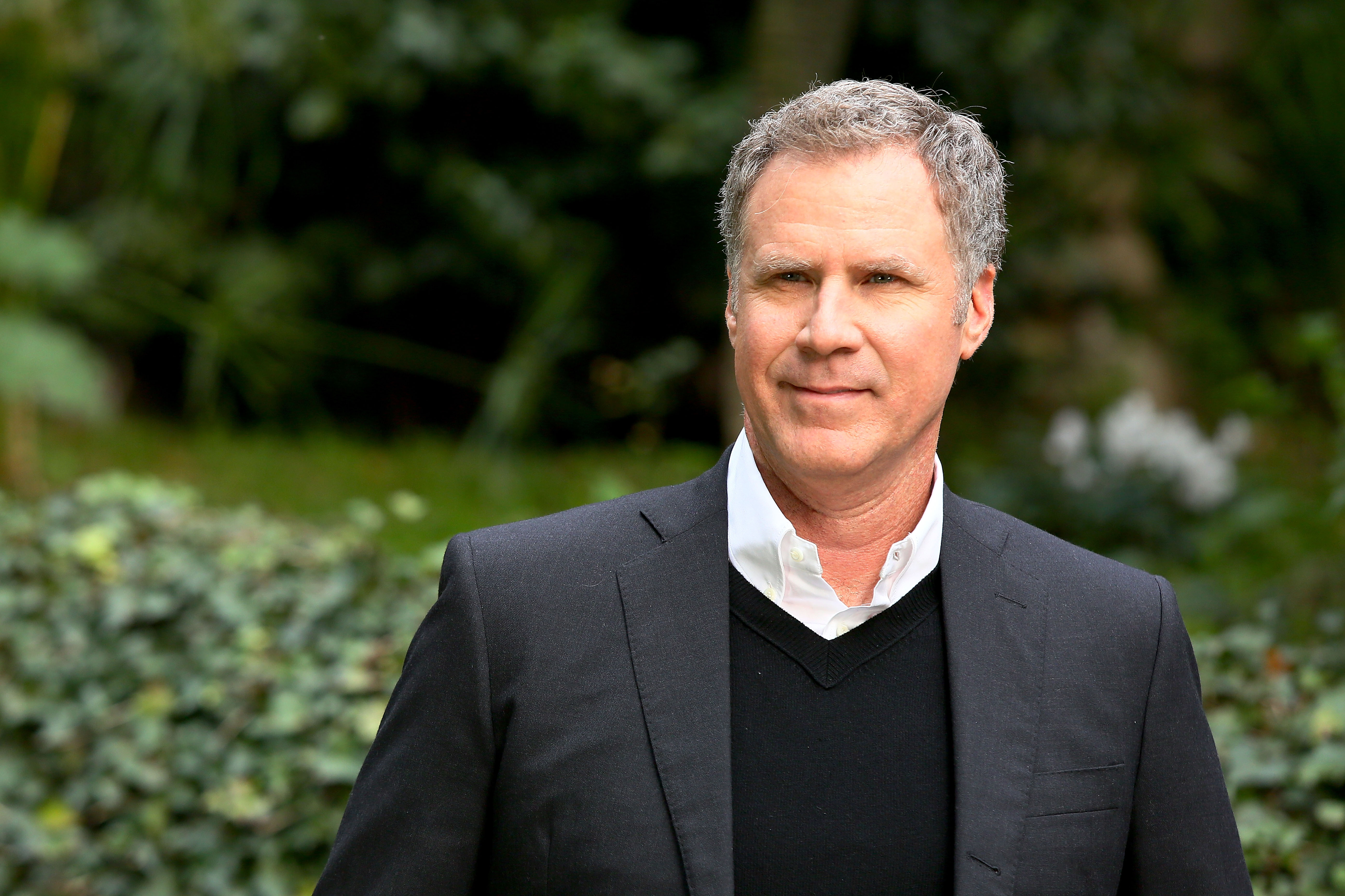 Will Ferrell poses in a sweater vest with a suit jacket.