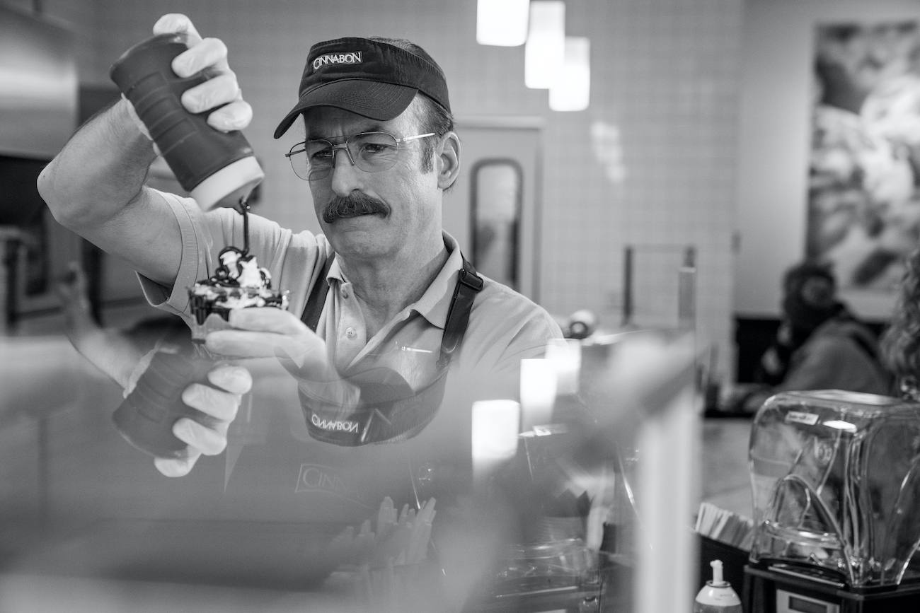 Gene Takavic (Bob Odenkirk) swirls frosting on a cinnamon bun working at Cinnabon in 'Better Call Saul' Season 6