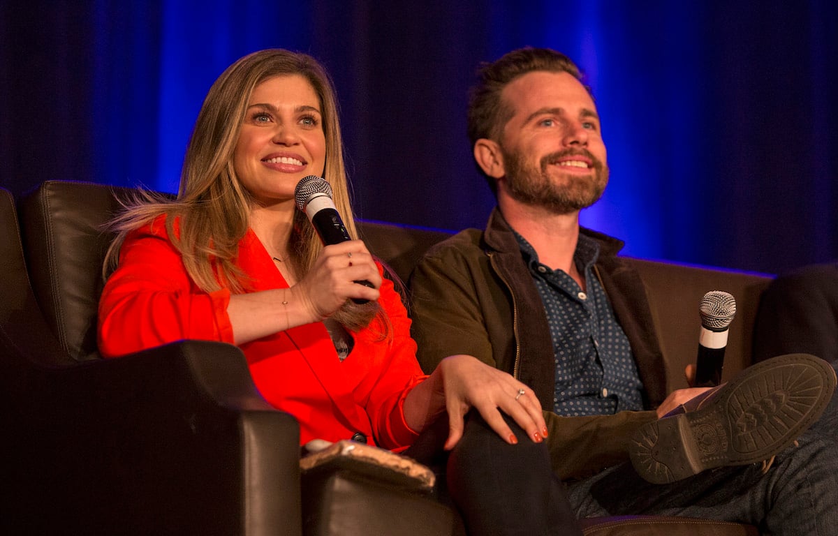 Danielle Fishel and Rider Strong of the Boy Meets World cast sitting and holding microphones