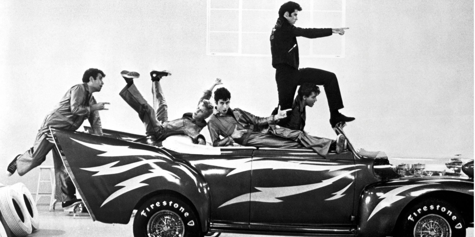 John Travolta and the 'Grease' cast filming the 'Greased Lightnin' segment of the film.