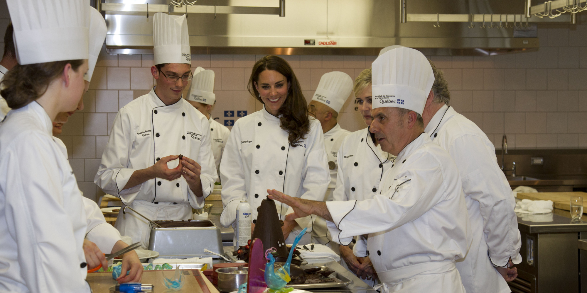 Kate Middleton wears chefs whites at a cooking demonstration in Canada.