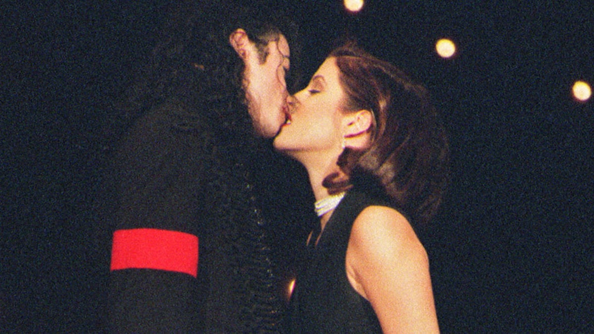Michael Jackson kisses Lisa Marie Presley on stage at the MTV VMA's in 1994.