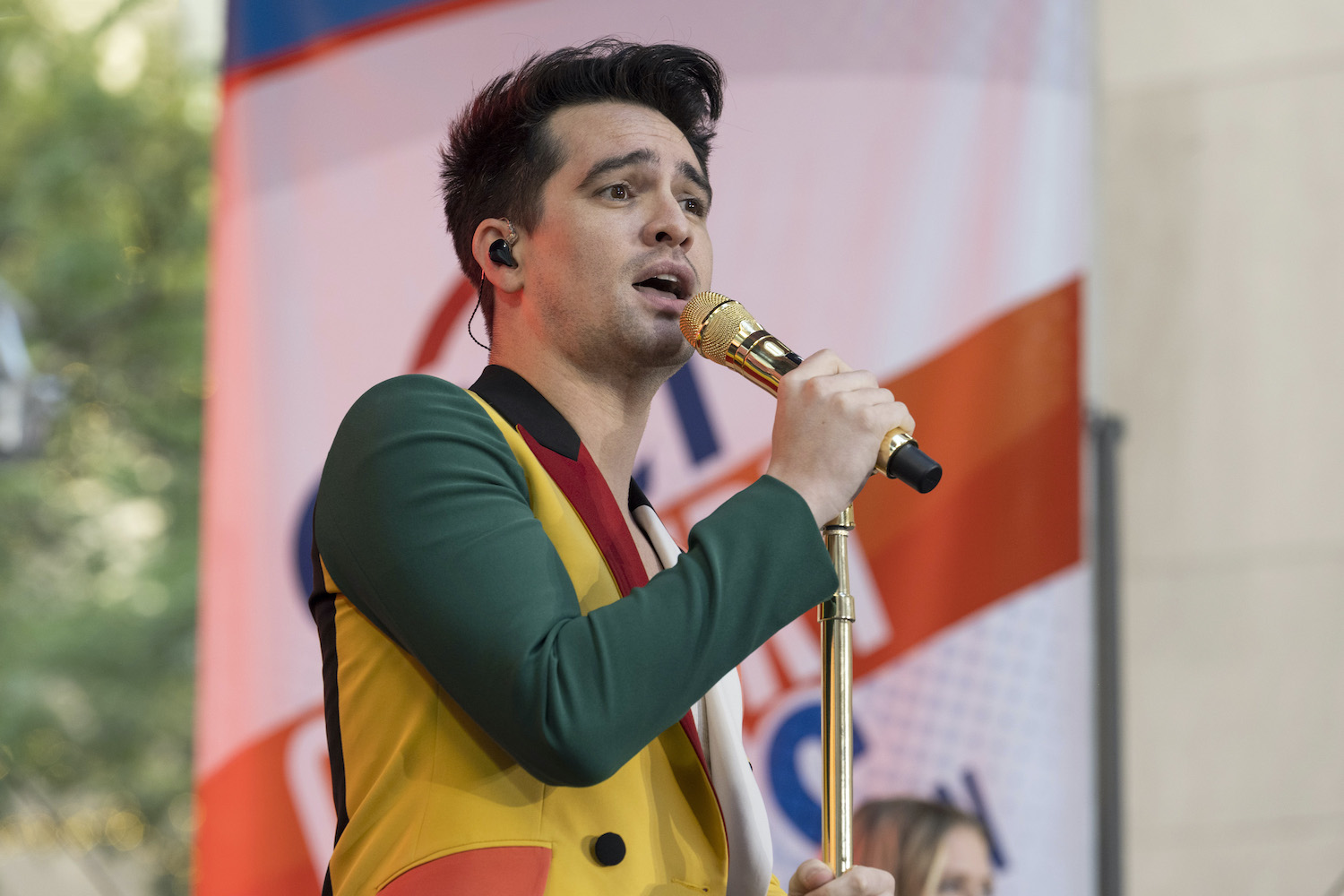 Brendon Urie wears a multi-colored jacket and sings with Panic! At The Disco during a 2022 Today show performance
