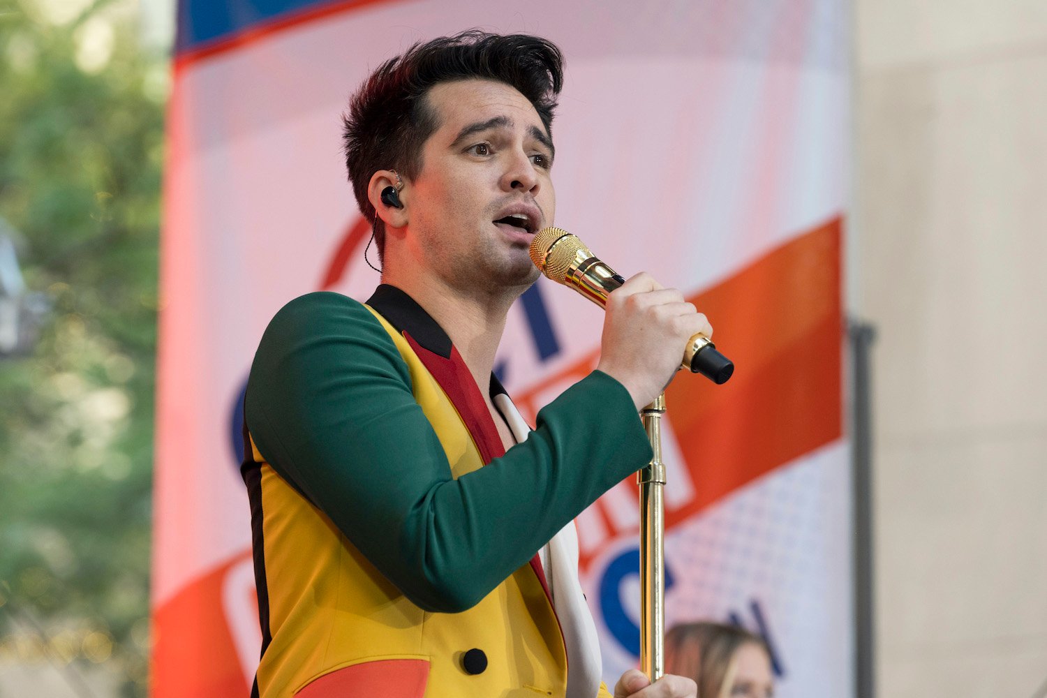 Brendon Urie wears a multi-colored jacket and sings with Panic! At The Disco during a 2022 Today show performance