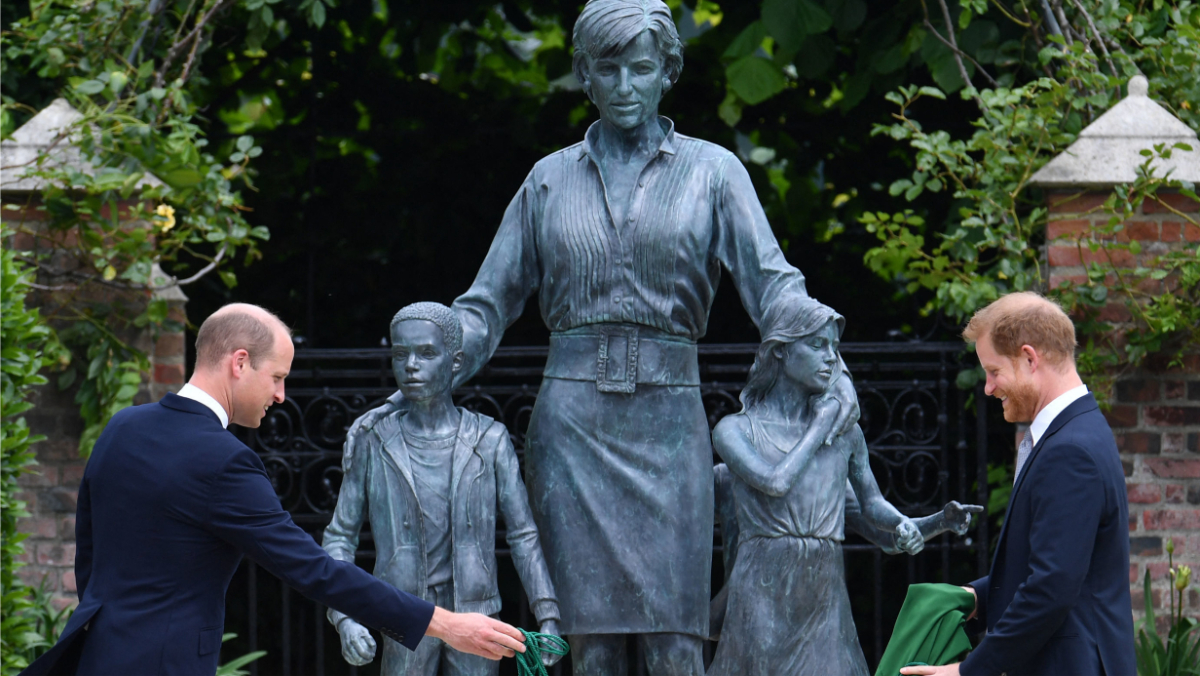 Princes William and Harry with a statue honoring their mother Princess Diana.