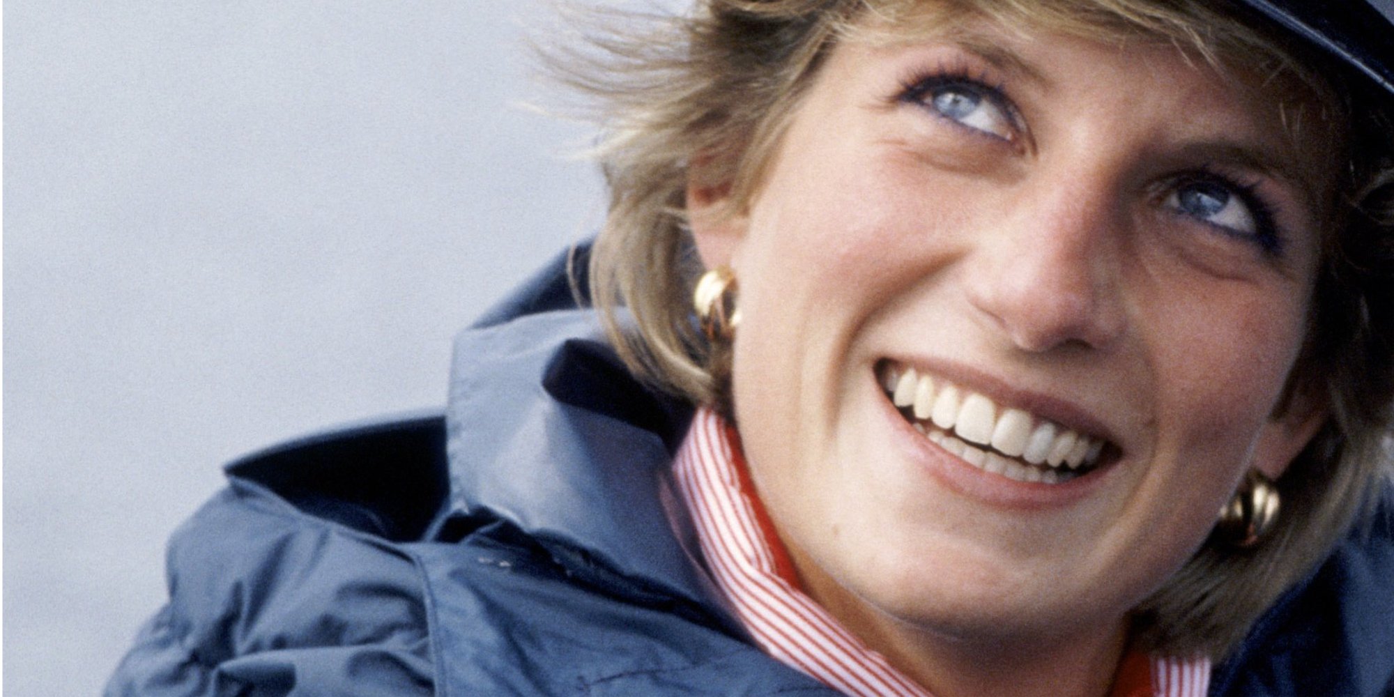Princess Diana smiles wearing a naval hat in an archival photograph.