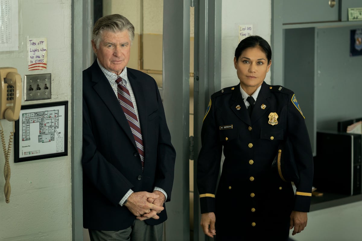 Treat Williams wearing a suit standing next to Celeste Oliva in police uniform in HBO's 'We Own This City'