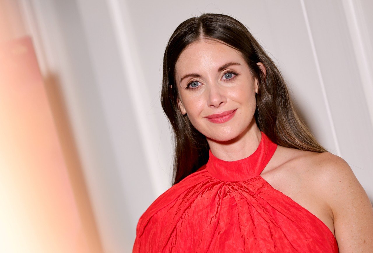 Alison Brie wears a red dress during her attendance at the Los Angeles screening of "Spin Me Around."