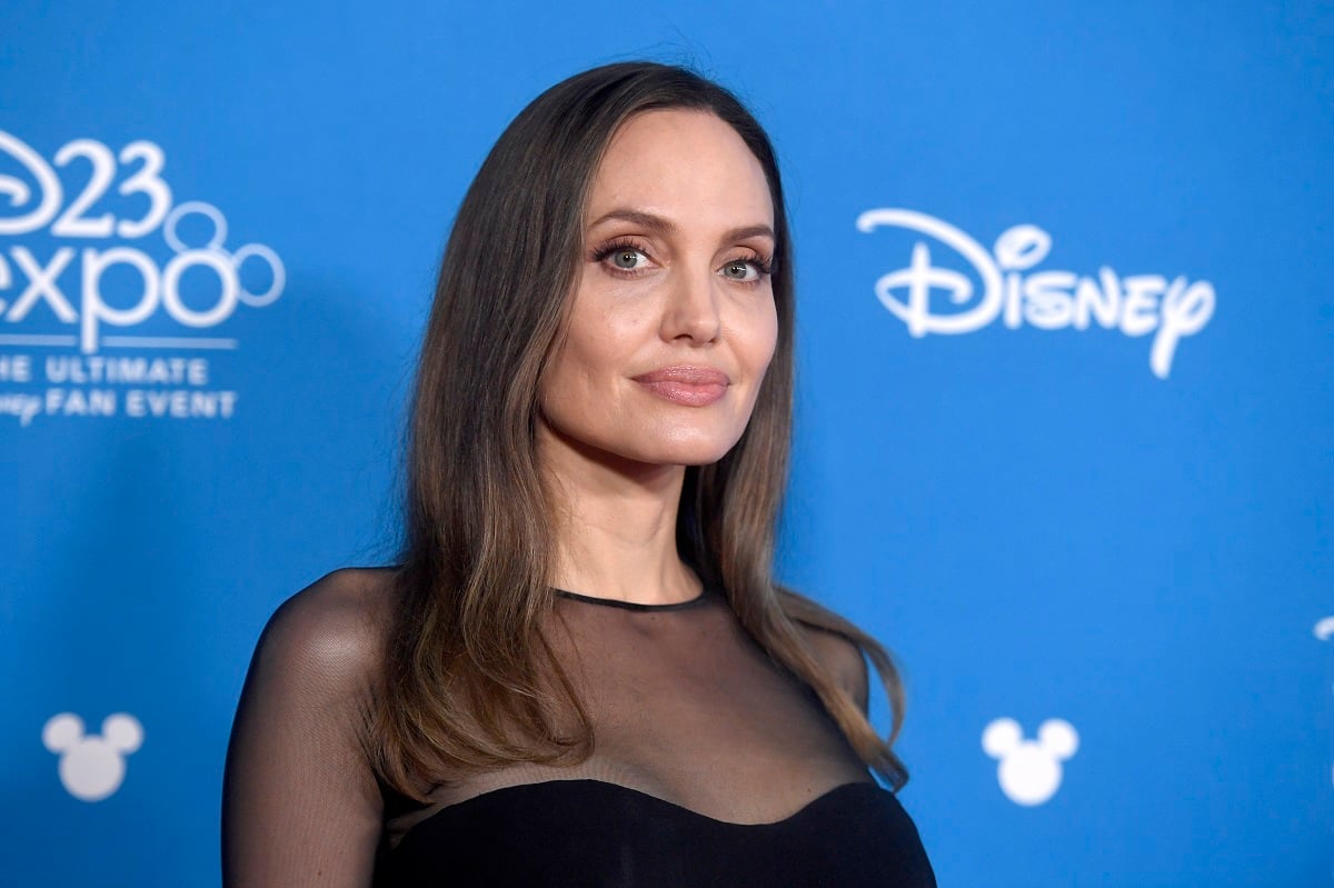 Angelina Jolie posing at the D23 Expo.