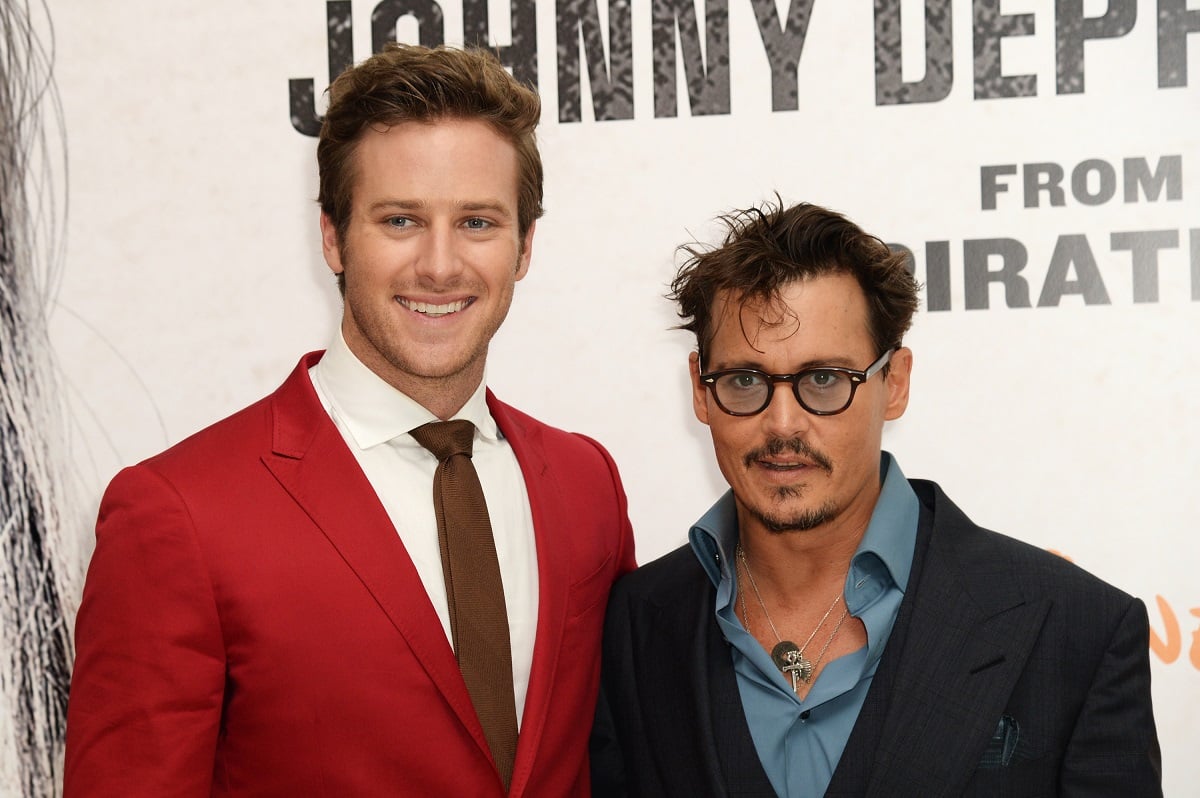 Armie Hammer smiling alongside Johnny Depp.