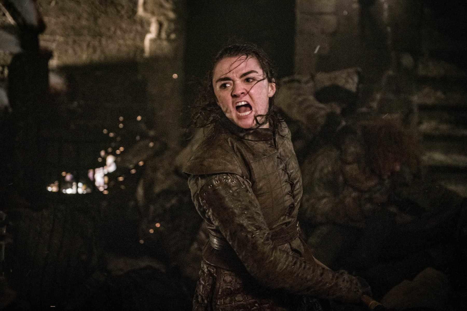 Maisie Williams as Arya Stark for our article on potential Game of Thrones spinoffs. She is fighting at the Battle of Winterfell and something is burning behind her.