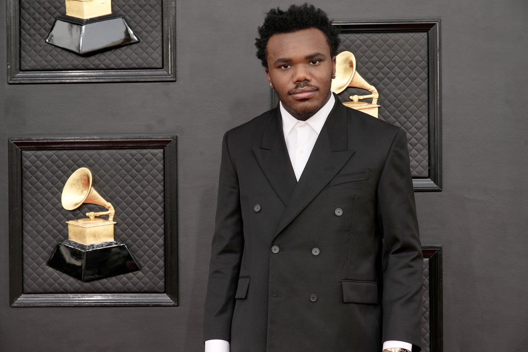Baby Keem, Kendrick Lamar's cousin, wearing a suit at the Grammy Awards.