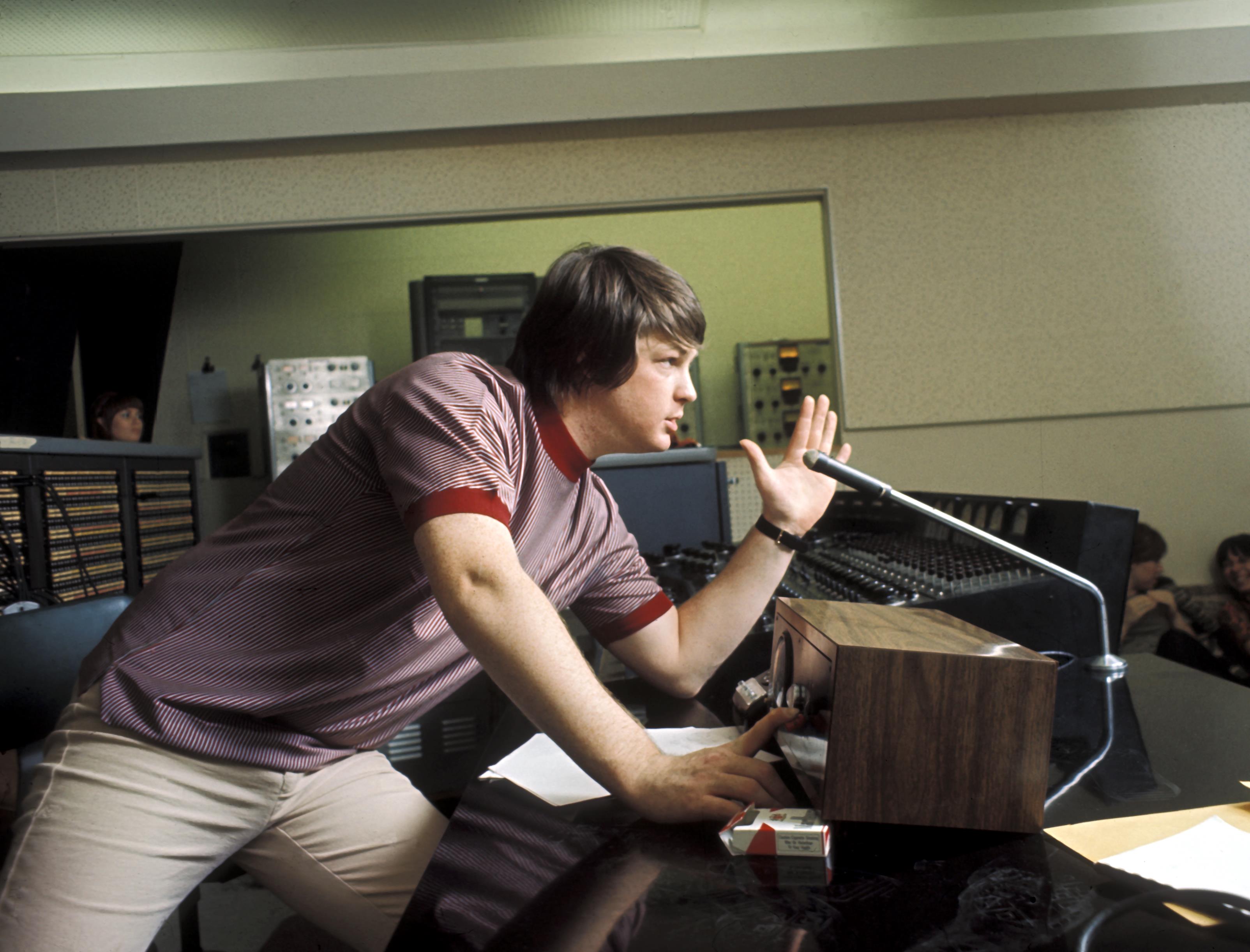 Singer Brian Wilson of the rock and roll band The Beach Boys directs from the control room while recording 'Pet Sounds'