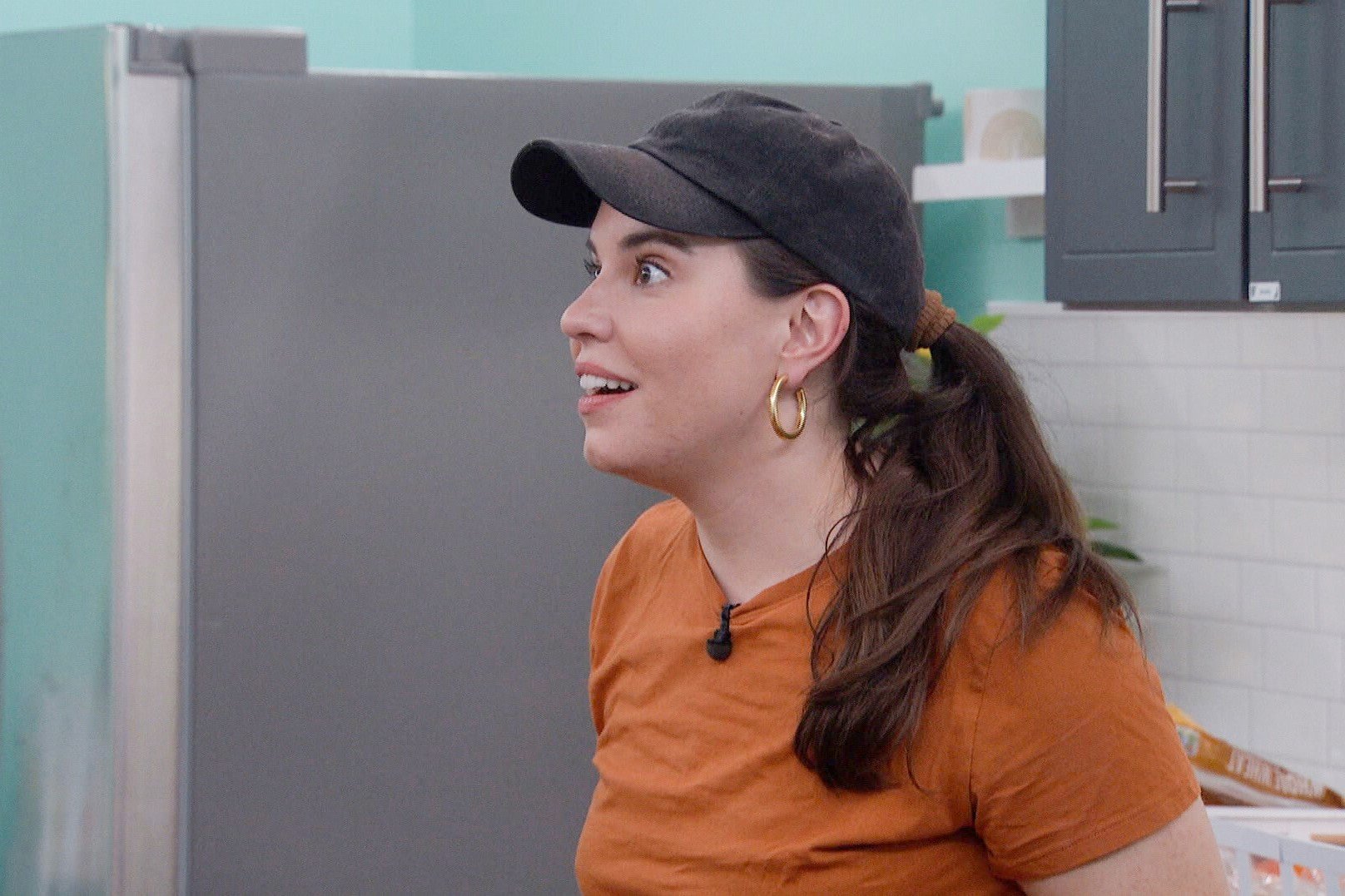 Brittany Hoopes, who stars in 'Big Brother 24' on CBS, wears an orange shirt and black baseball cap