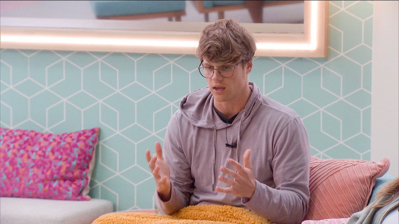 Kyle Capener sits on the living room couch in a hoodie on 'Big Brother 24'.