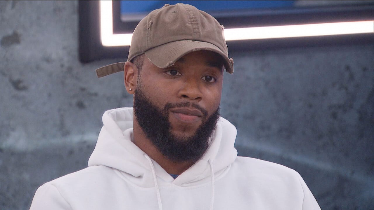 Monte Taylor looks serious while wearing a hat and hoodie on 'Big Brother 24'.