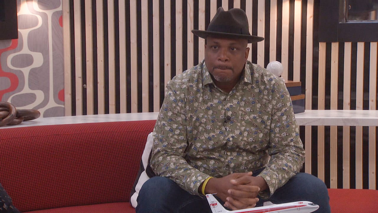 Terrance Higgins sits in the HOH room wearing a shirt and hat on 'Big Brother 24'.