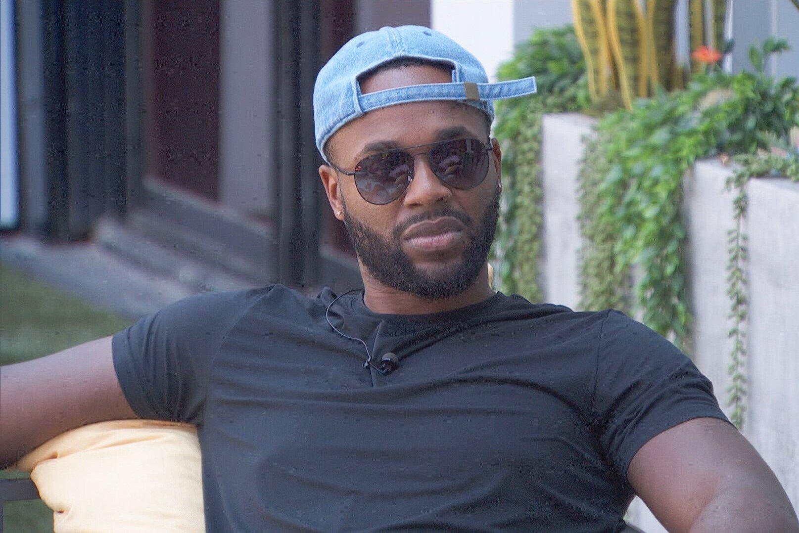 Monte Taylor, who, according to 'Big Brother 24' spoilers, made the final four, wears a black shirt, light blue baseball cap backwards, and sunglasses.